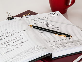 Open 2015 Planner With Black Pen And Red Mug On Desk