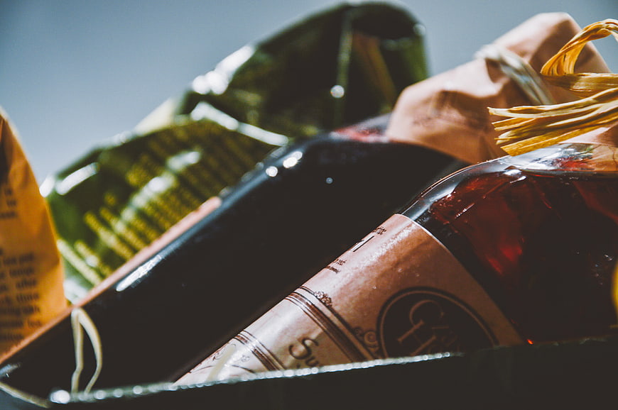 Close-up of wine bottles and groceries in a shopping basket