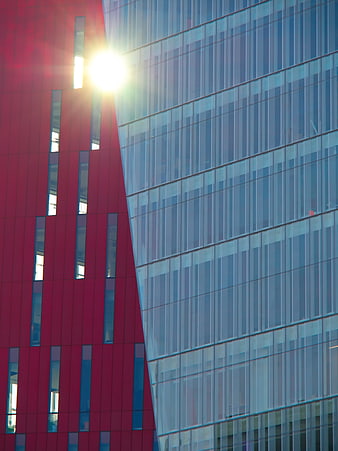 Modern Red and Blue Glass Building Facade with Sun Flare