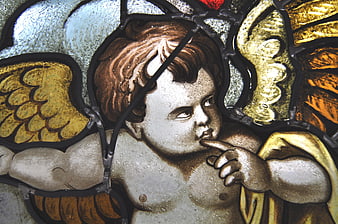 Close-up of a stained glass angel with golden wings