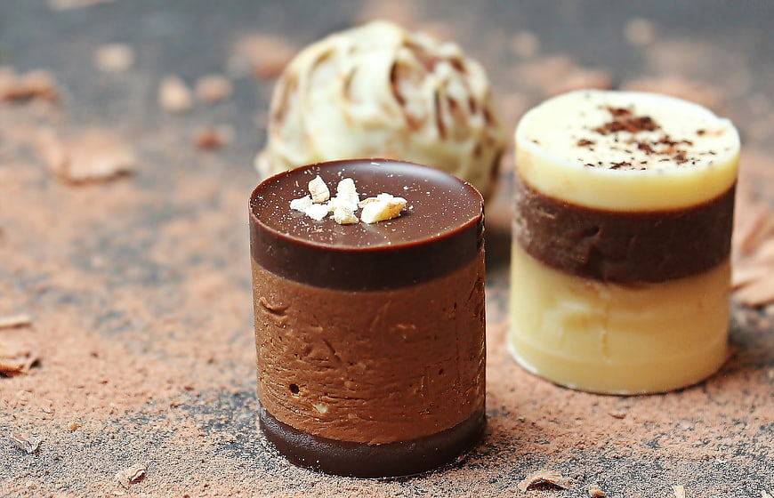 Gourmet Chocolate Truffles and Pralines on Rustic Surface