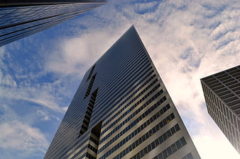 Low angle view of modern skyscrapers against blue sky