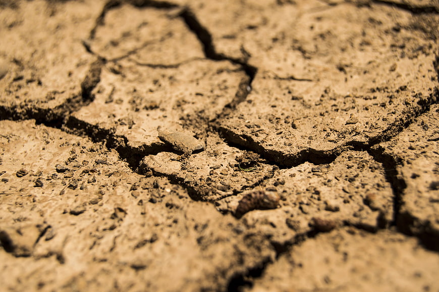 Close-up of cracked dry earth soil texture