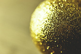 Close-up of Golden Glitter Christmas Ornament with Bokeh