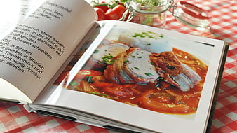 Open Cookbook with Pork Recipe on Checkered Tablecloth