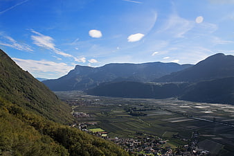 Panoramic Alpine Valley with Vineyards and Mountains