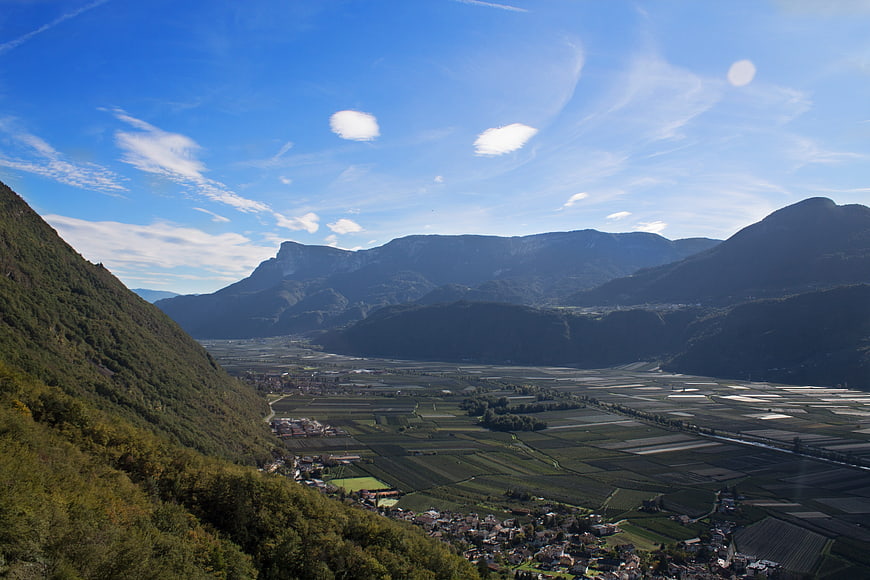 Panoramic Alpine Valley with Vineyards and Mountains