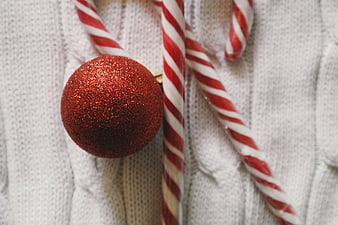 Red Glitter Christmas Ornament and Candy Canes on White Knit