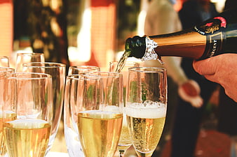 Pouring Champagne into Flutes at a Celebration