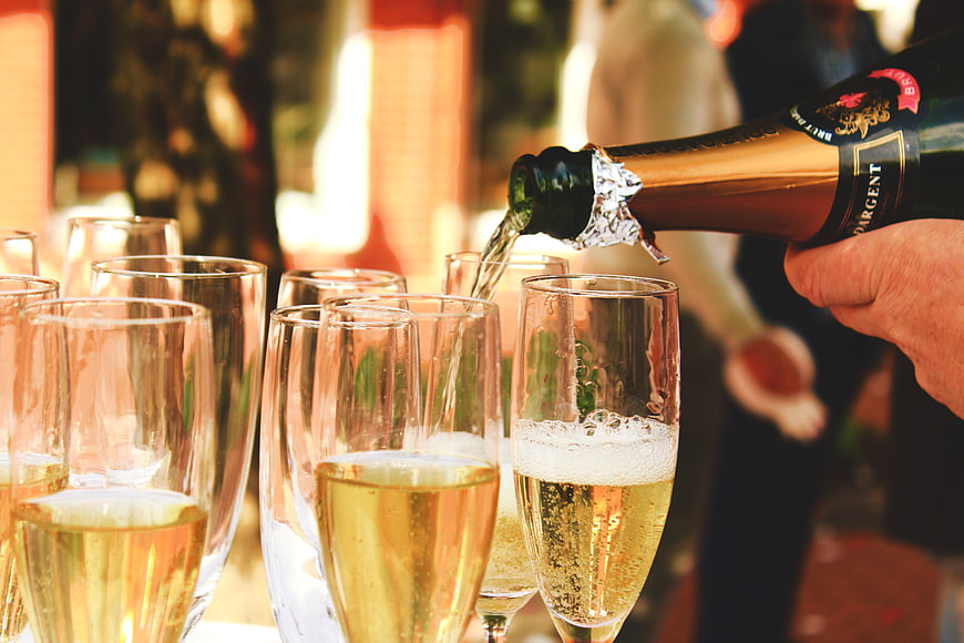 Pouring Champagne into Flutes at a Celebration
