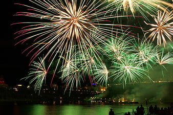 Spectacular Fireworks Display Over River at Night
