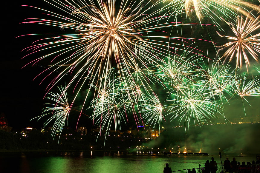 Spectacular Fireworks Display Over River at Night