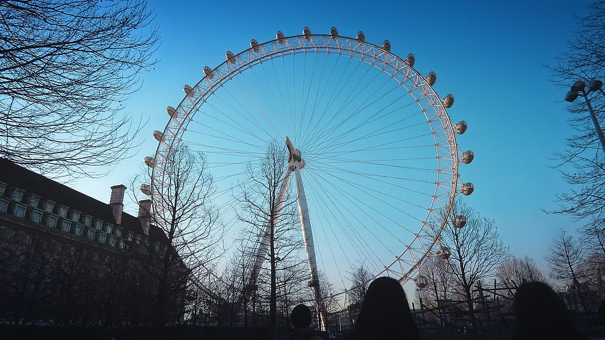 London Eye Ferris Wheel Silhouette Against Blue Sky