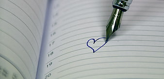 Fountain pen drawing blue heart on lined notebook page
