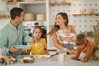 Happy family eating breakfast together in modern kitchen