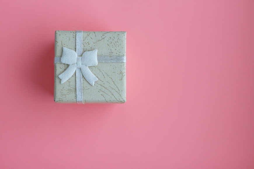 Elegant Gift Box With White Bow On Pink Background
