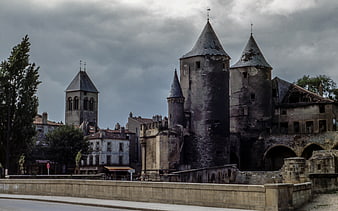 Historic Medieval Castle Towers Under Dramatic Cloudy Sky