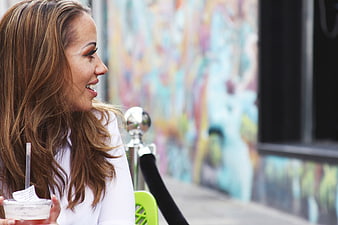 Smiling Woman with Drink at Outdoor Cafe