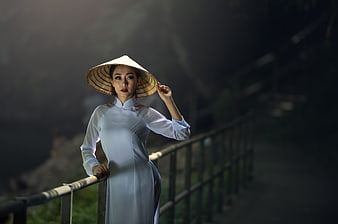 Asian Woman in Traditional Vietnamese Ao Dai and Conical Hat