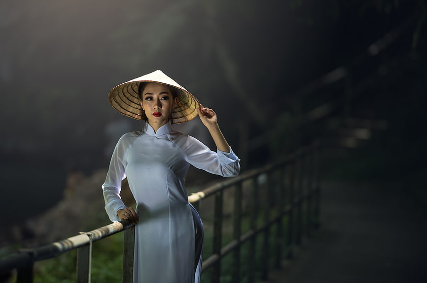 Asian Woman in Traditional Vietnamese Ao Dai and Conical Hat