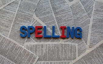 Spelling word made of colorful foam letters on newspaper background