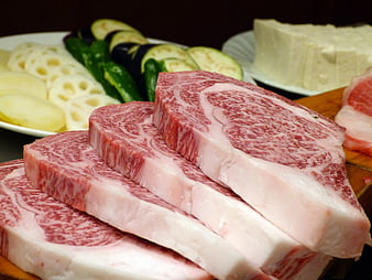 Raw Wagyu Beef Steaks with Marbled Fat and Vegetables