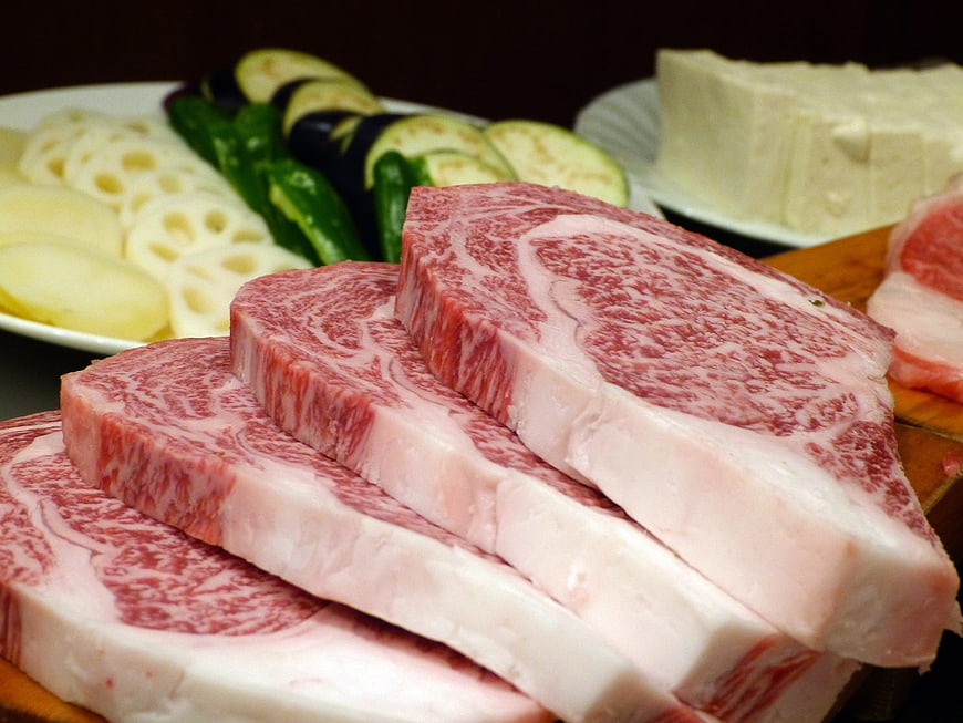 Raw Wagyu Beef Steaks with Marbled Fat and Vegetables