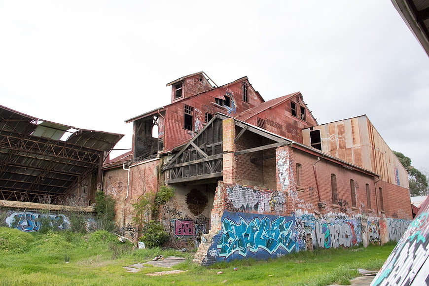 Abandoned red brick industrial building with graffiti