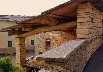Rustic Stone Architecture with Wooden Beams and Pillars