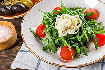 Arugula Salad With Cherry Tomatoes And Creamy Cheese On Ceramic Plate