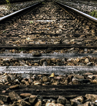 Low angle view of weathered railroad tracks and gravel