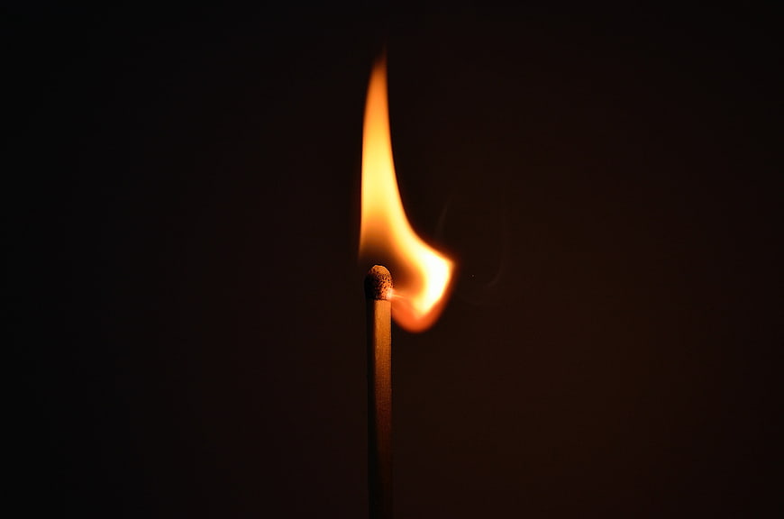 Burning Matchstick Flame on Black Background