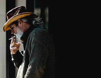 Senior man with beard smoking cigarette in profile