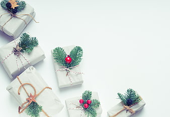 Minimalist Christmas Gifts Wrapped in White Paper with Pine Branches