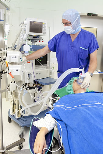 Anesthesiologist Managing Patient Airway In Operating Room