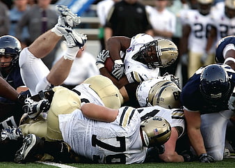 American Football Players Tackling in Action