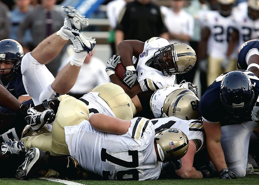 American Football Players Tackling in Action
