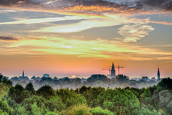 Sunrise over Groningen skyline with Martini Tower and trees
