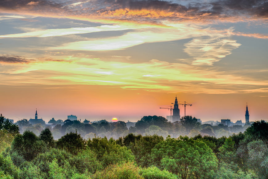 Sunrise over Groningen skyline with Martini Tower and trees