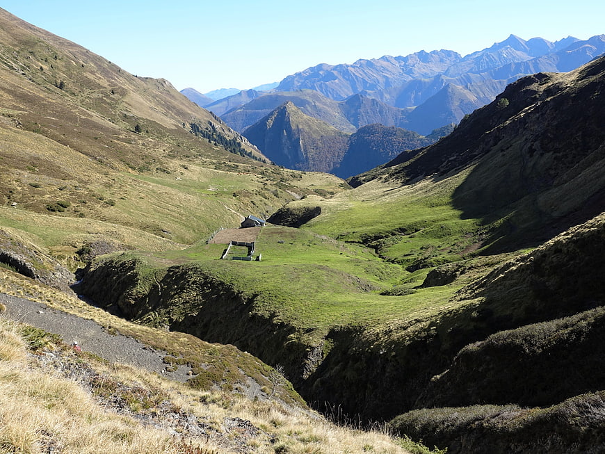 Scenic Mountain Valley with Cabin and Distant Peaks