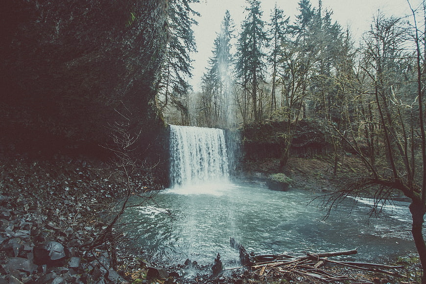 Misty Waterfall in Dark Forest with River
