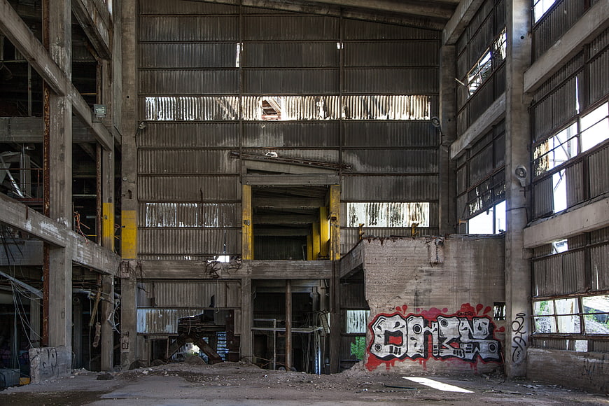 Interior of Abandoned Industrial Factory with Graffiti and Decay