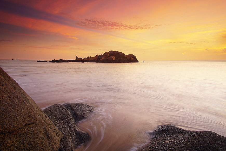 Serene Sunset Seascape with Rocky Island and Smooth Water