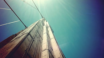 Low angle view of steel bridge structure against blue sky