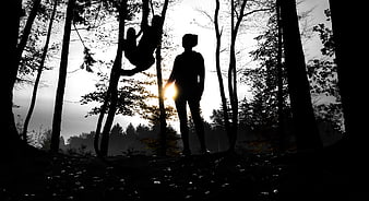 Silhouette of Mother and Child Playing in Forest