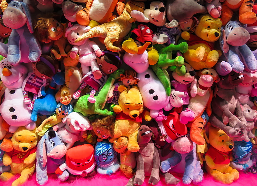 Colorful pile of Disney plush toys and stuffed animals