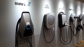 Row of Electric Vehicle Chargers on White Wall