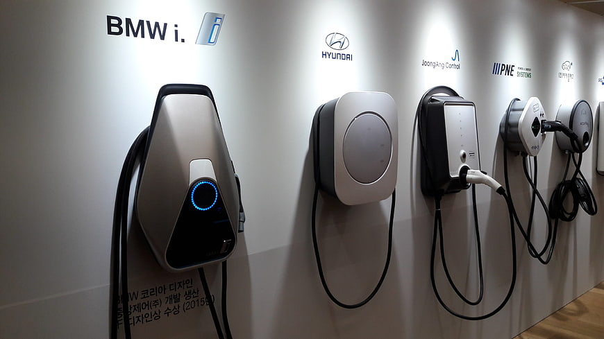 Row of Electric Vehicle Chargers on White Wall