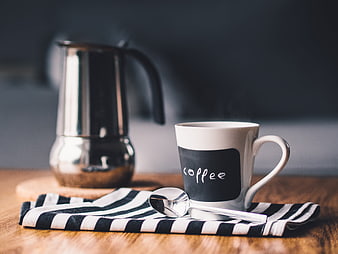 Steaming Coffee Mug and Moka Pot on Wooden Table