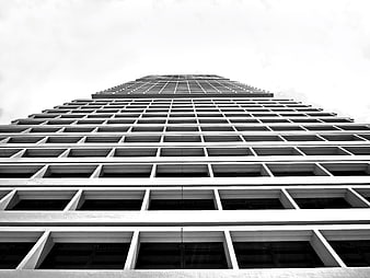 Low angle black and white skyscraper facade with grid pattern